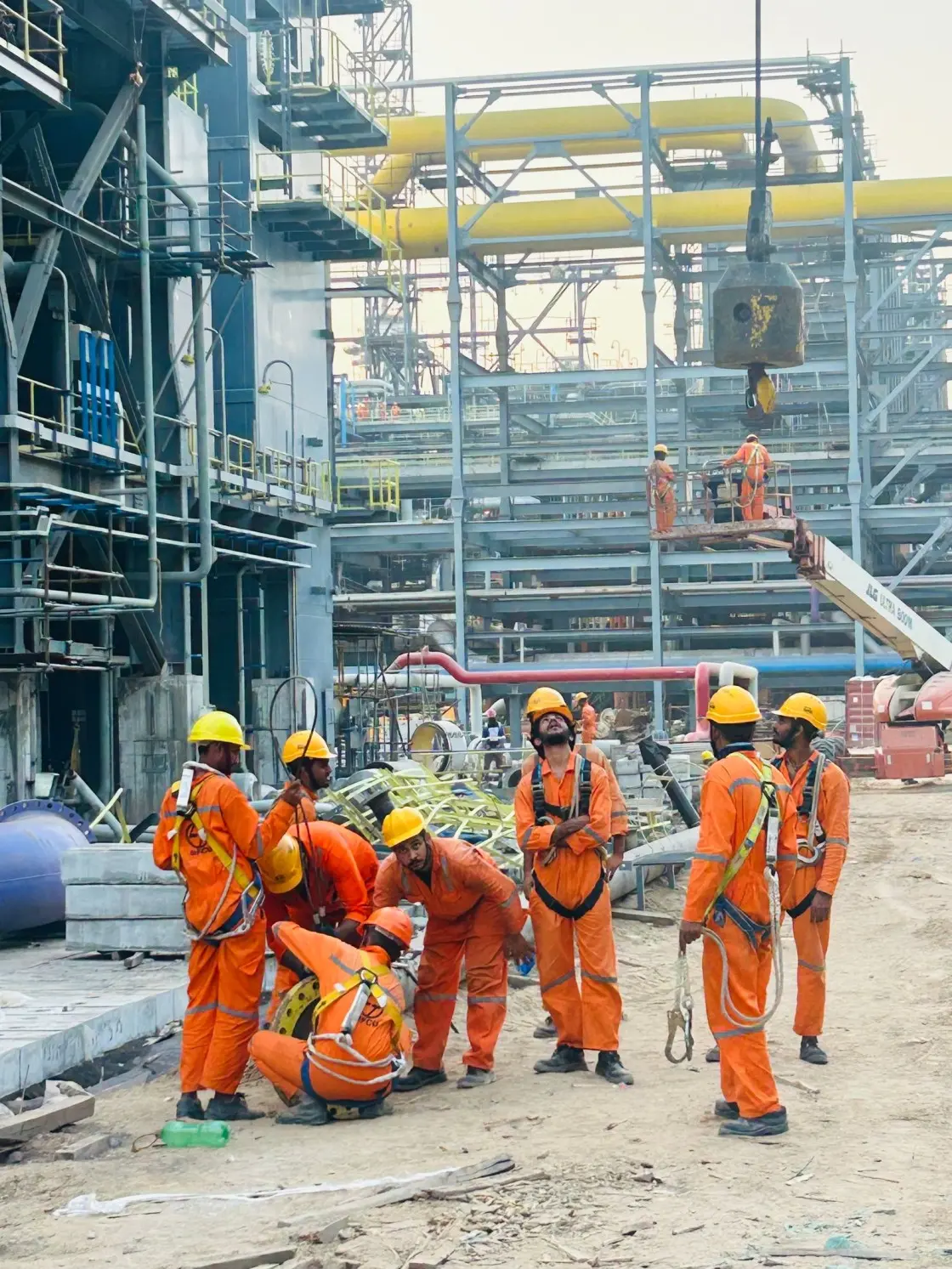 Construction workers working at a large industrial construction site